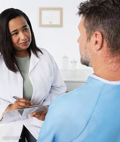 Man talking to doctor about psoriasis