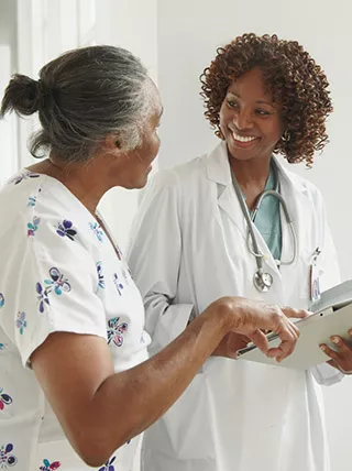 Photo of patient and doctor standing and talking