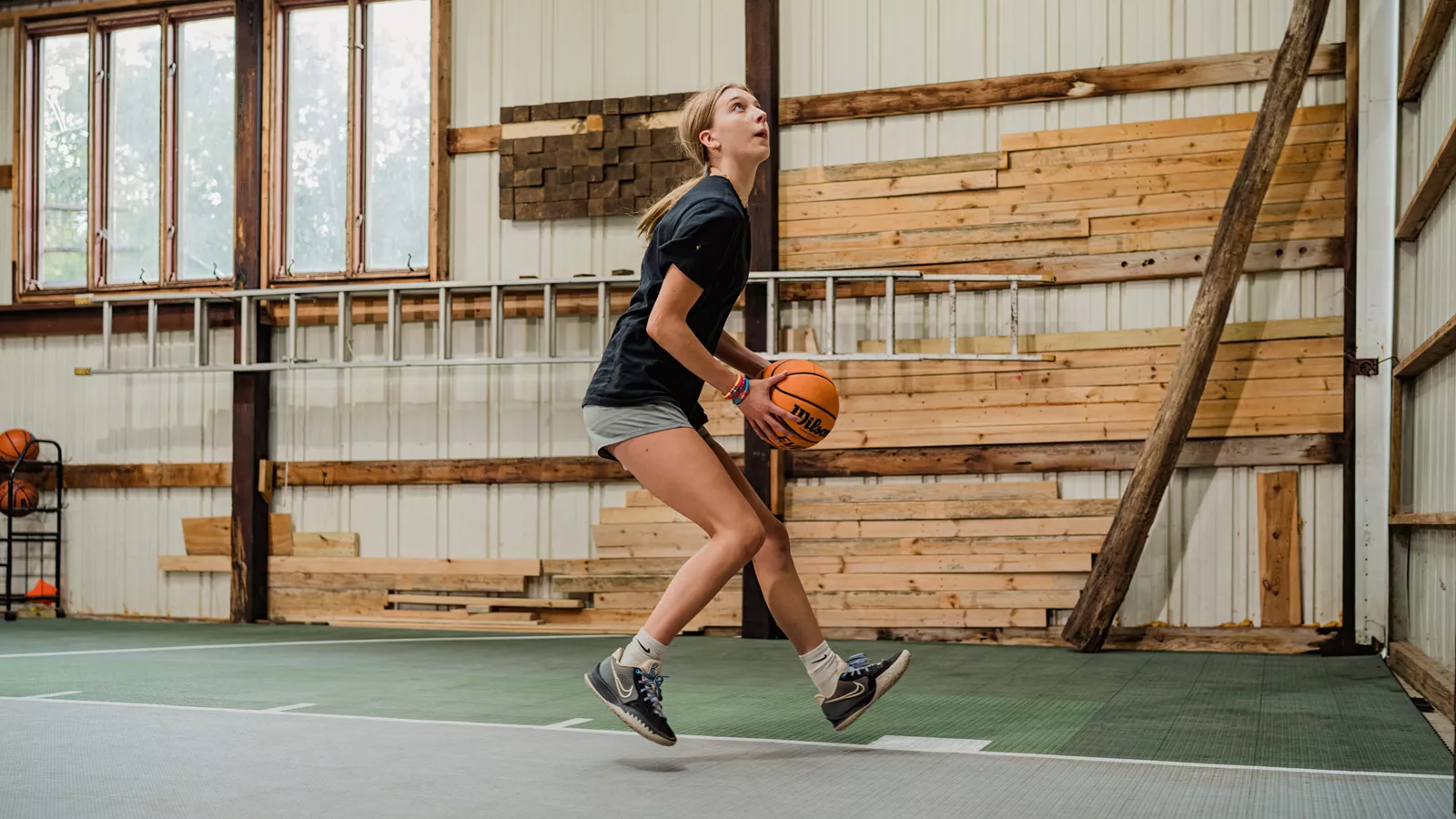 teenage girl playing basketball