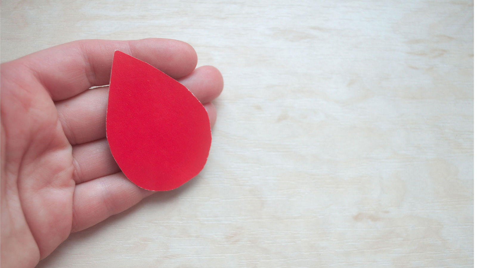 World Blood Donor Day. World Hemophilia Day. Hand holds a drop of blood. World Hemophilia Day. World Diabetes Day.