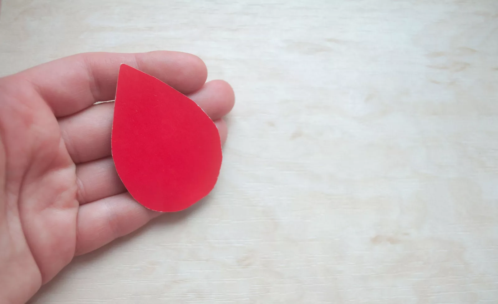 World Blood Donor Day. World Hemophilia Day. Hand holds a drop of blood. World Hemophilia Day. World Diabetes Day.