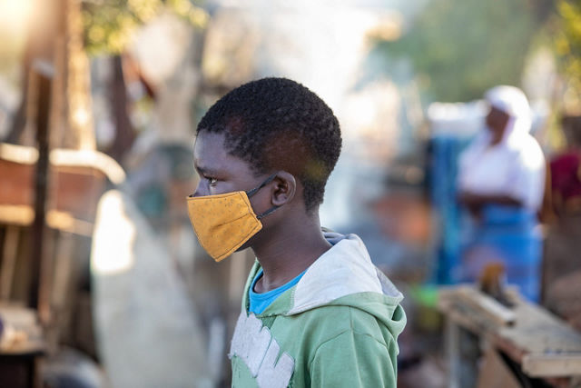 Side view of boy wearing a mask
