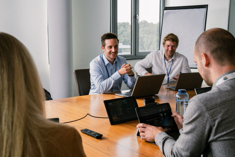 Gruppe von Mitarbeiter:innen in einem Meeting 