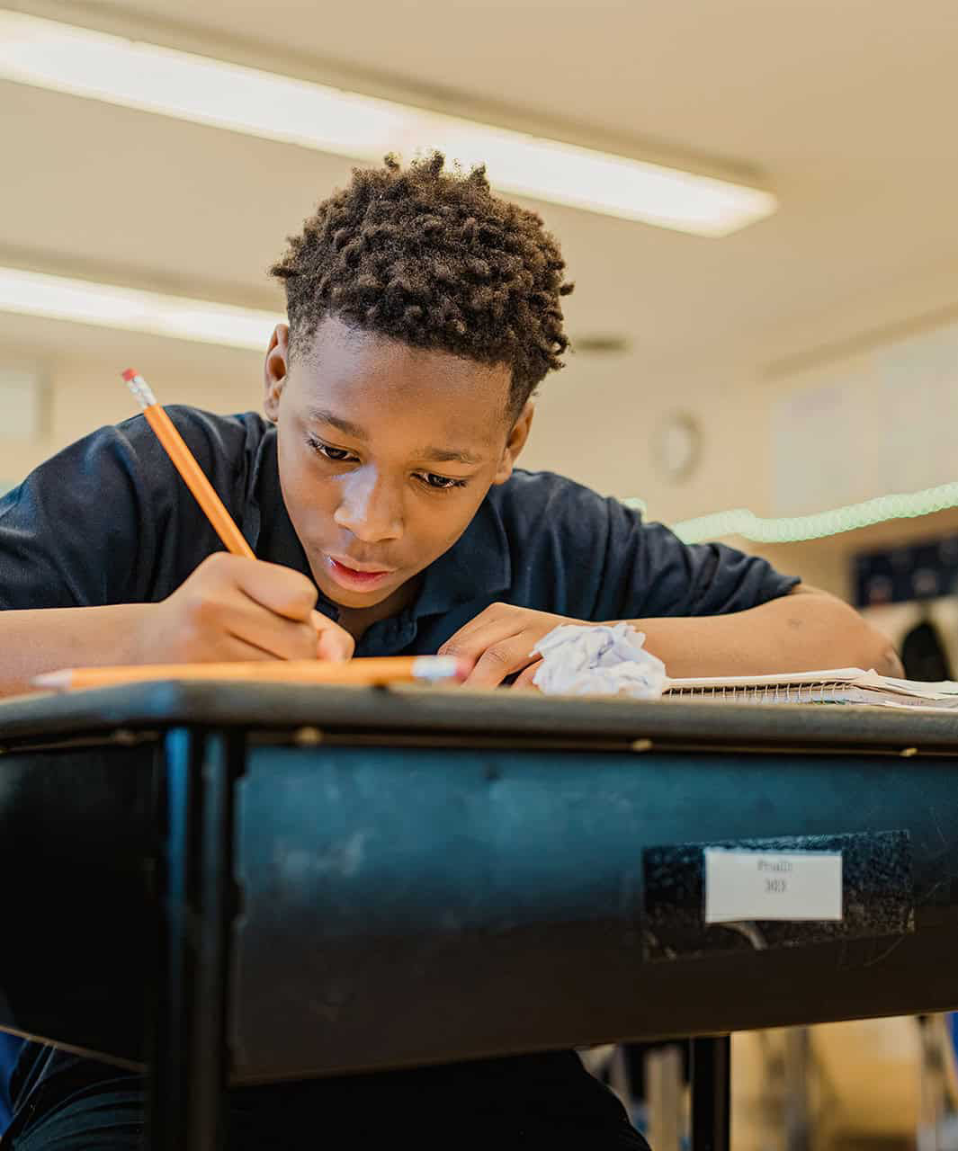 boy writing at desk