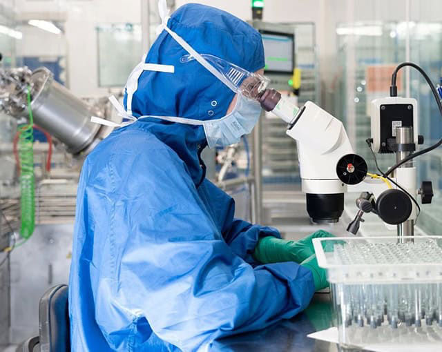 cere person looking at microscope