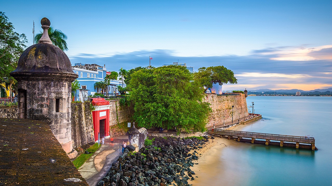 San Juan, Puerto Rico Caribbean coast along Paseo de la Princesa at dusk.