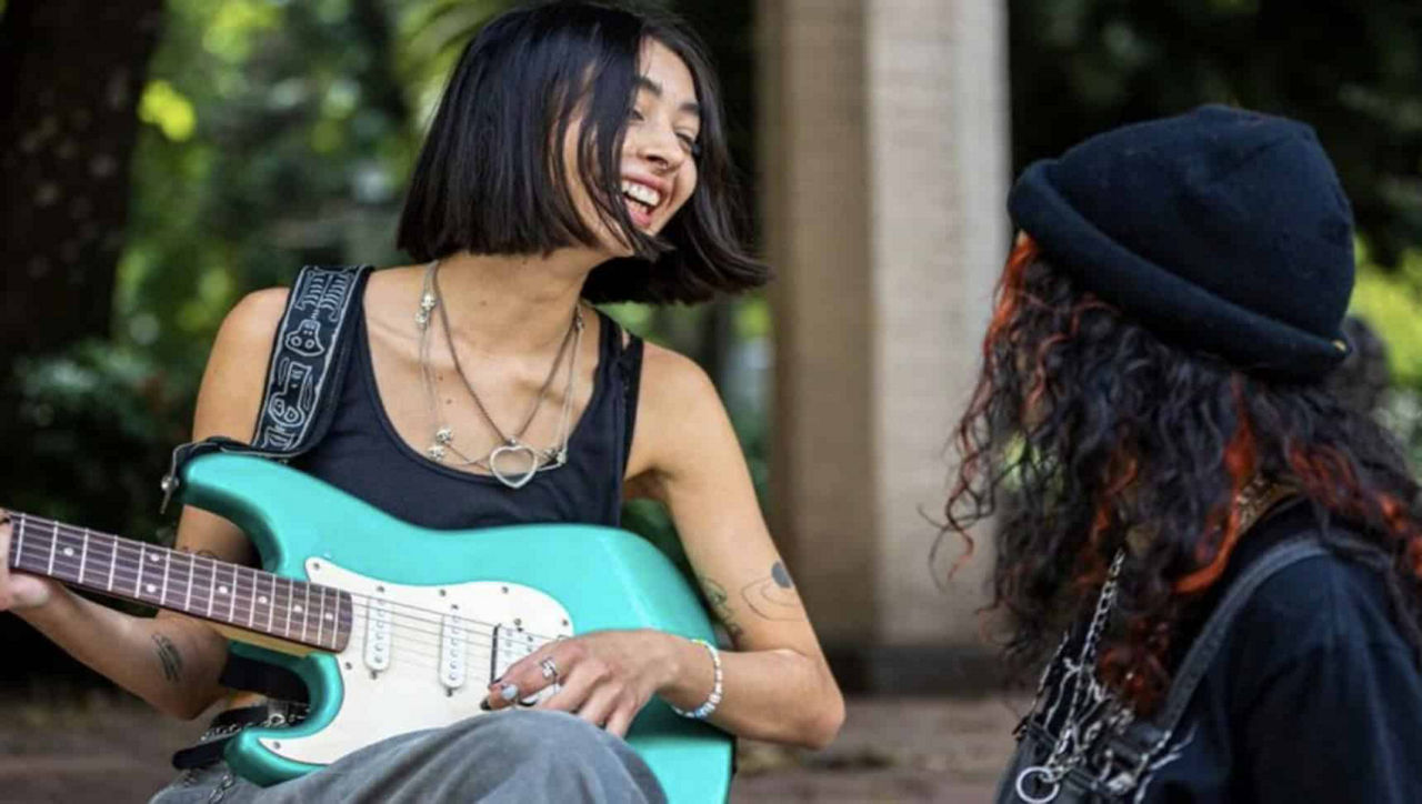 female playing guitar
