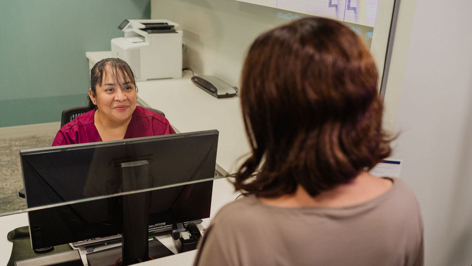 woman at front desk at dr office