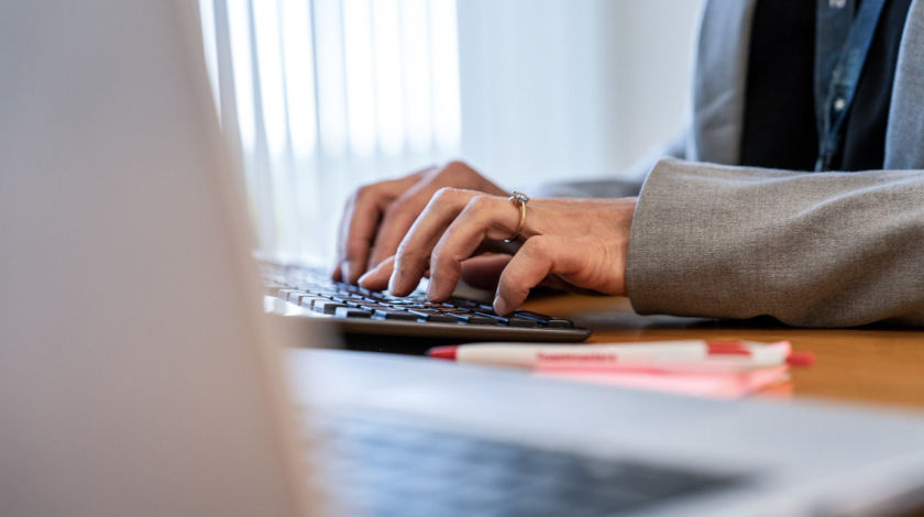 hands typing on laptop