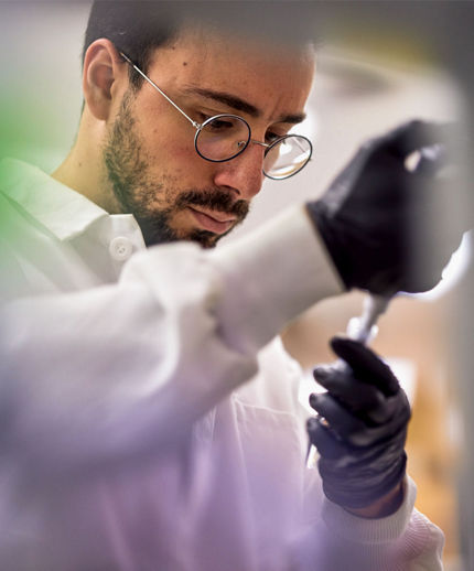 man looking at pipette
