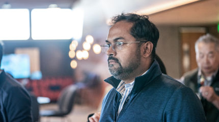 man standing watching presentation