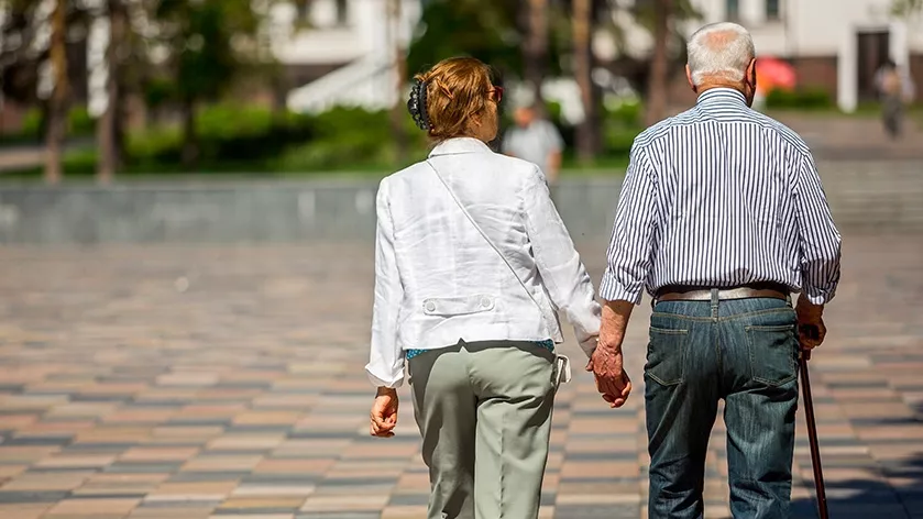 woman and man walking down street