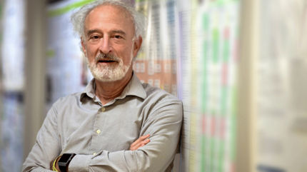 older man leaning on wall