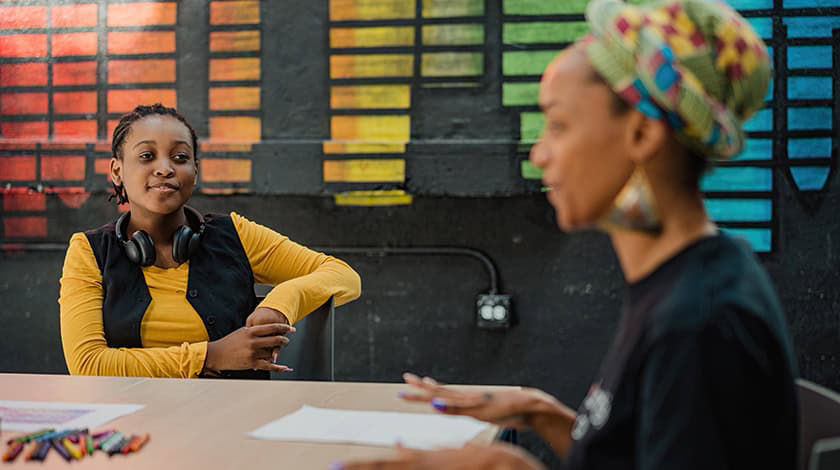 two females sitting at desk