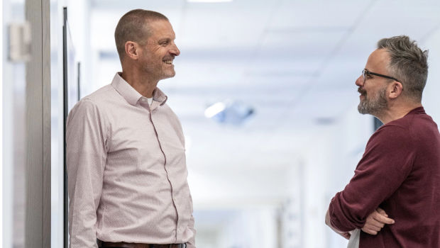 two men talking in hall