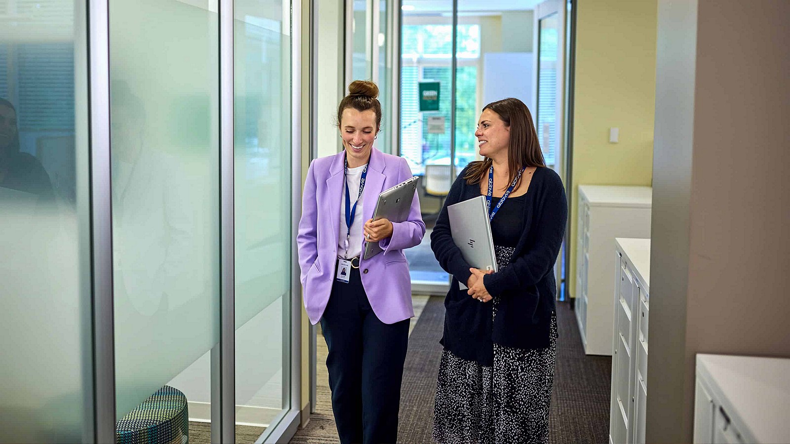 two women walking in hall