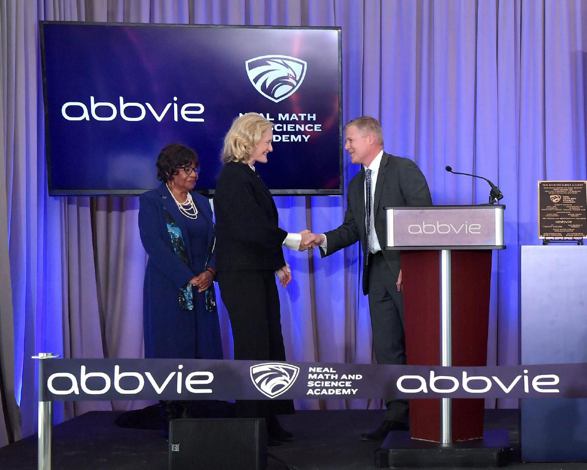 Laura S shaking hands with speaker