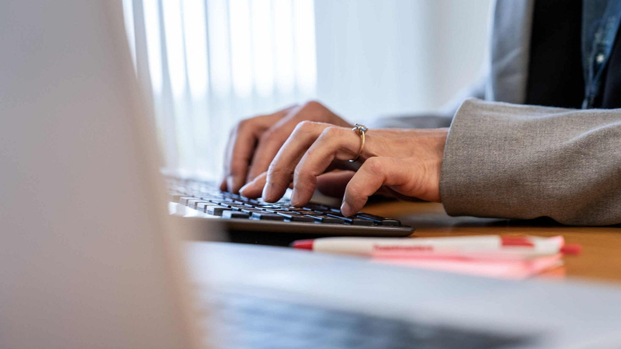 woman hands typing on laptop 