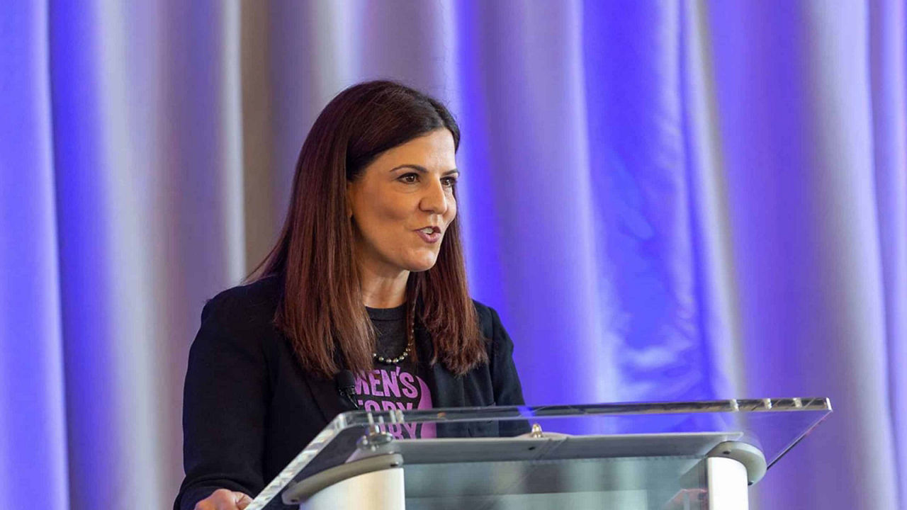 woman standing behind podium