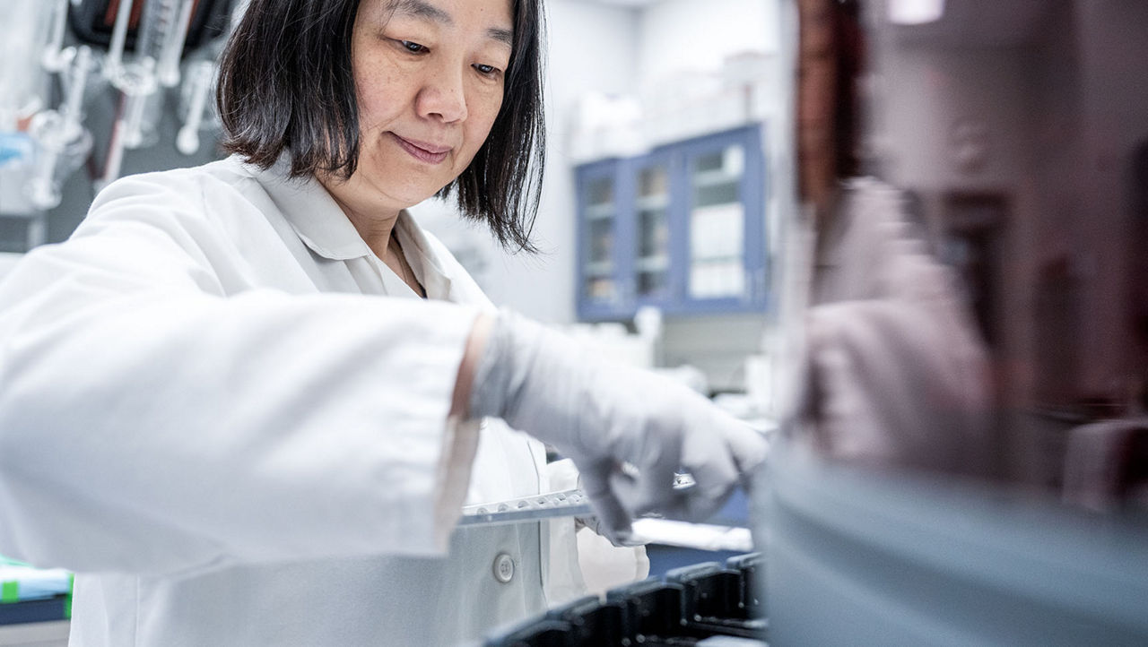 woman scientist looking down at device